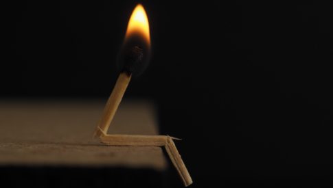 lighted-matchstick-on-brown-wooden-surface-750225
